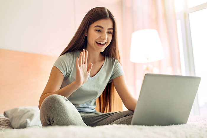 Teenage girl making a video call via laptop